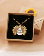 A gold necklace with a box